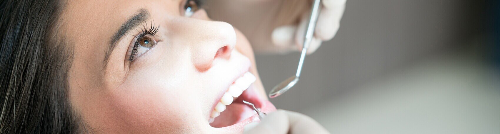 girl having her teeth examined